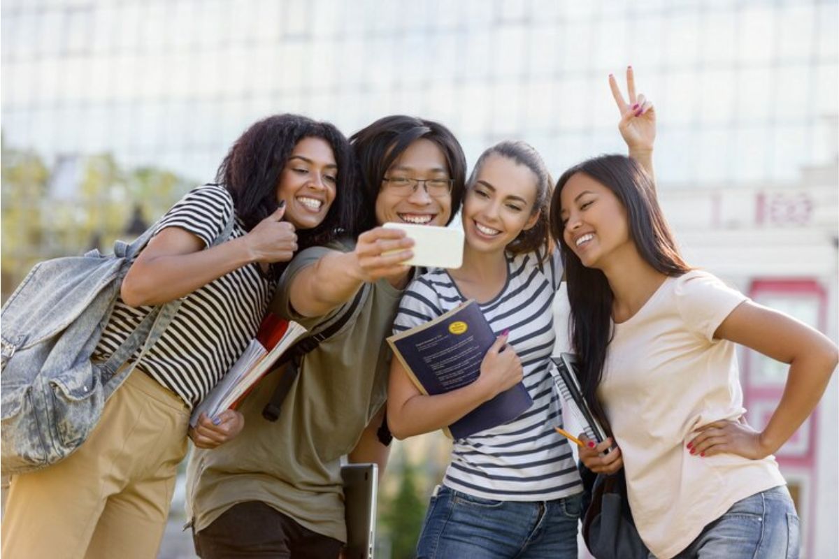 Um grupo de quatro estudantes fazendo uma selfie